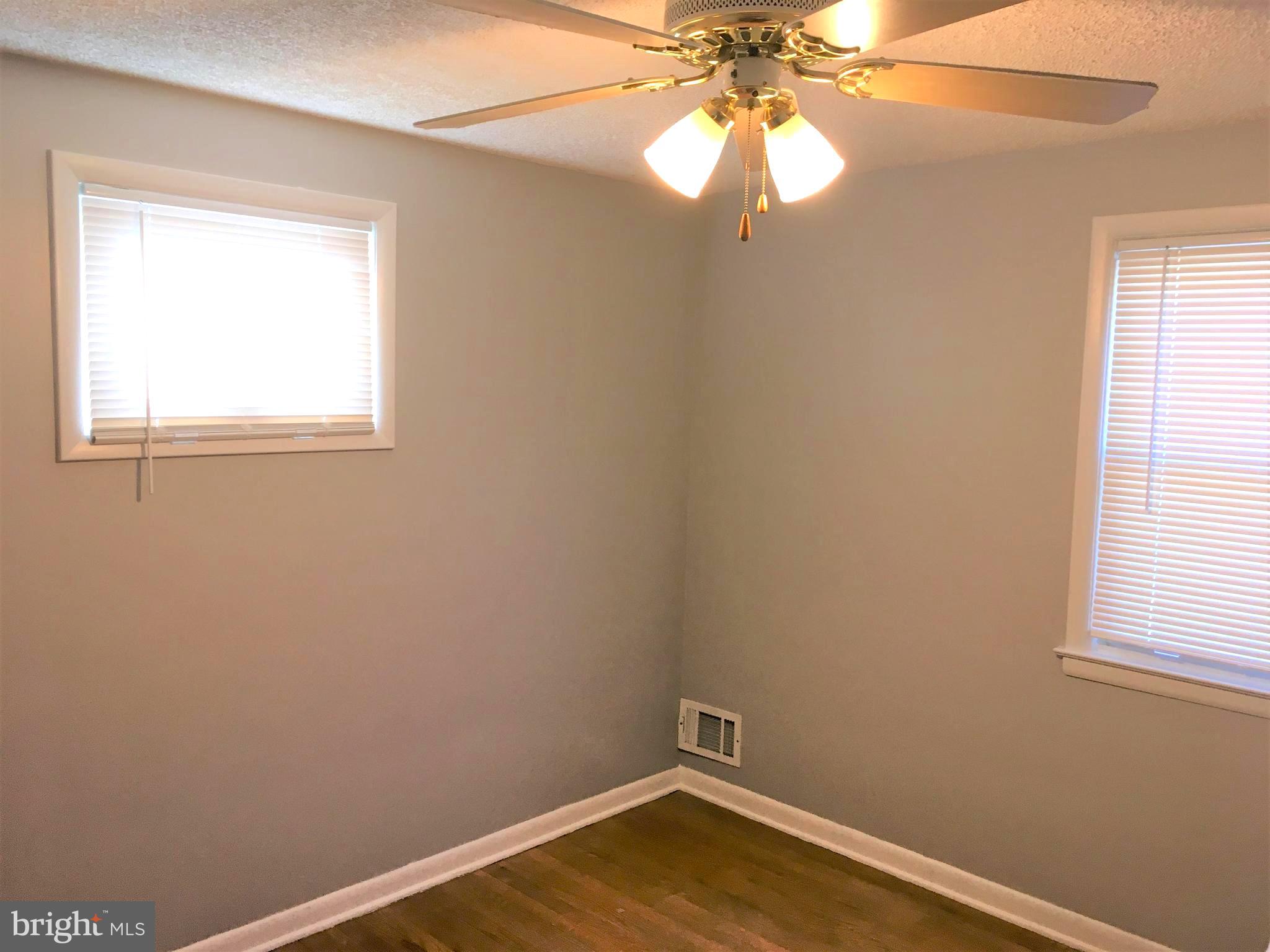 8103 Edwill Avenue Rosedale, MD 21237 - Photo 14 of 31 an empty room with a window and wooden floor