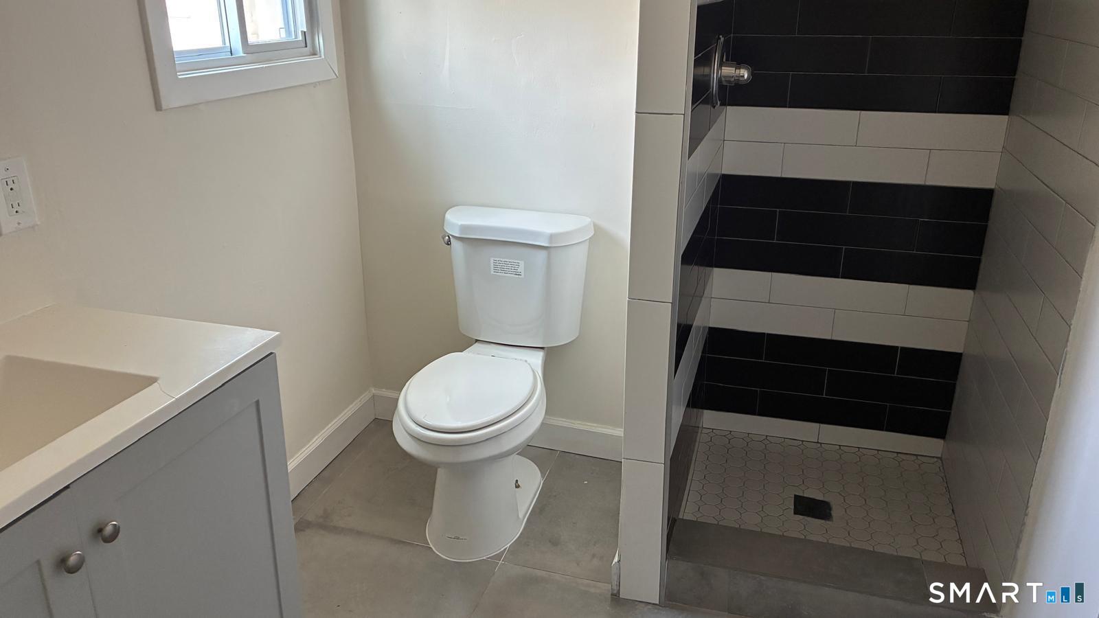 54 North Avenue, Unit 3 Meriden, CT 06451 - Photo 4 of 10 a bathroom with a toilet and a shower