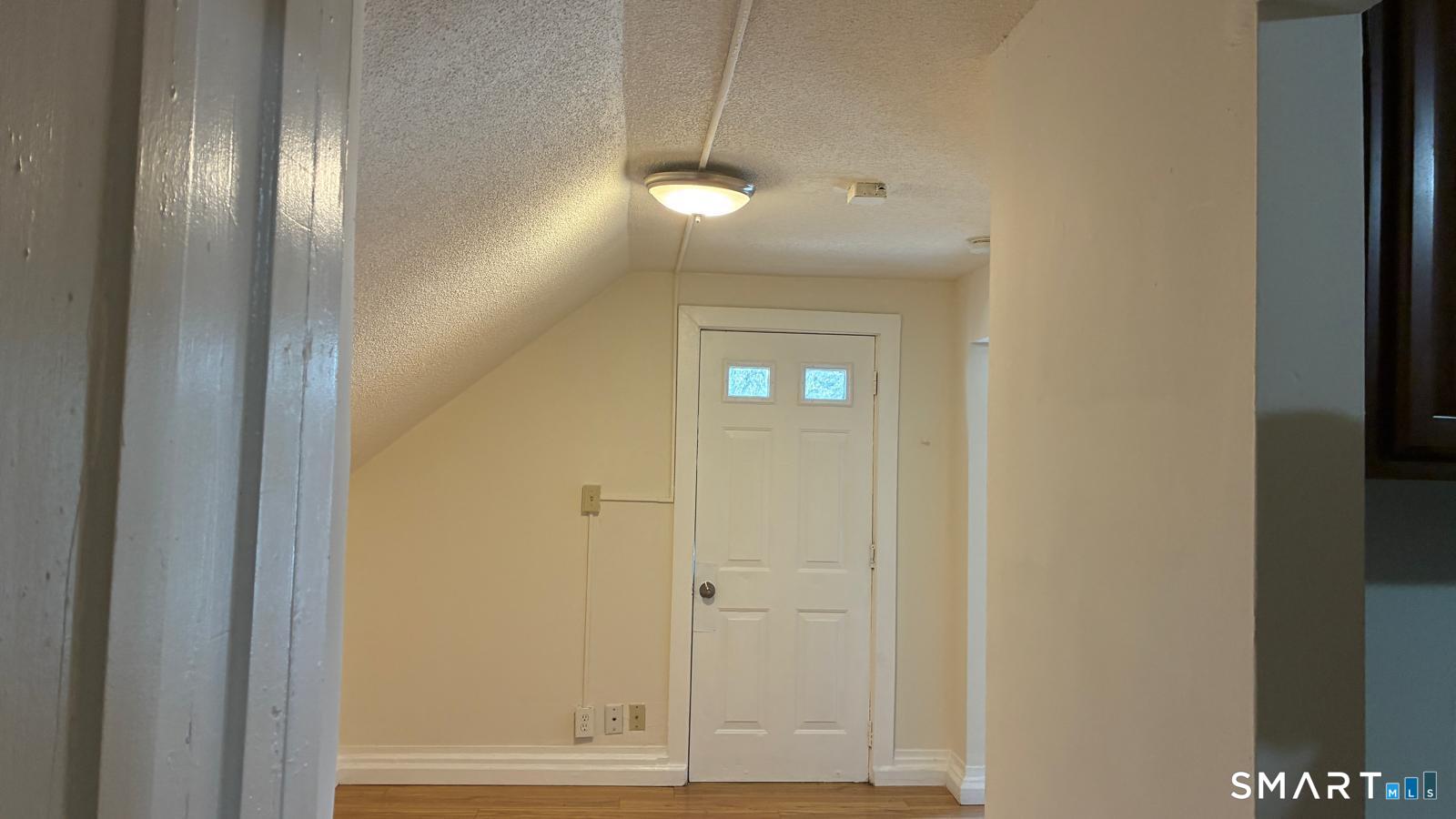 54 North Avenue, Unit 3 Meriden, CT 06451 - Photo 7 of 10 a view of a hallway with wooden floor