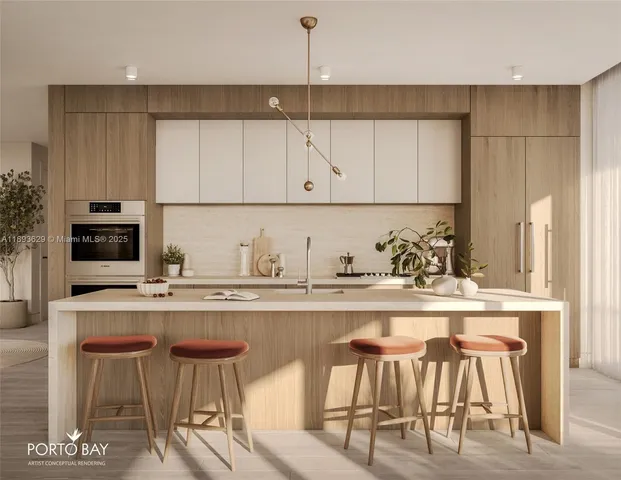 a kitchen with stainless steel appliances granite countertop a table chairs sink and cabinets