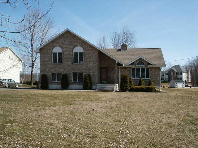 28 Alcott Road Wolcott, CT 06716 - Photo 1 of 1 a front view of a house with a yard