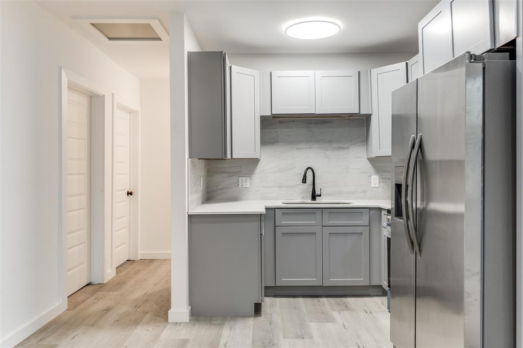 3242 Pine Street Dallas, TX 75215 - Photo 12 of 25 a kitchen with a sink stainless steel appliances and refrigerator