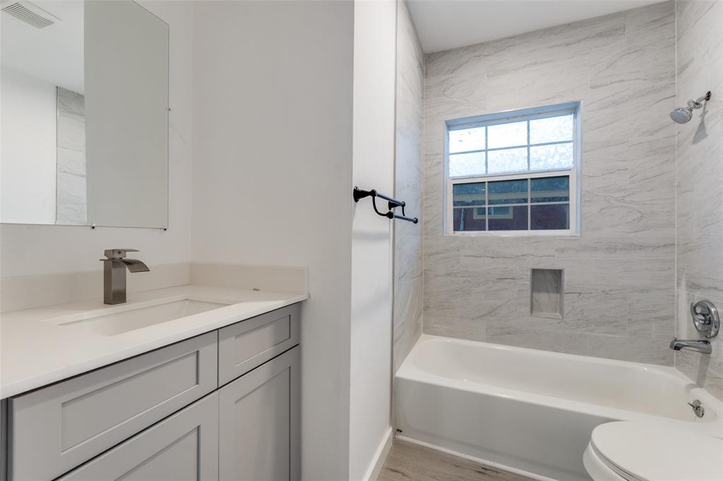 3242 Pine Street Dallas, TX 75215 - Photo 15 of 25 a bath room with a sink and a bath tub