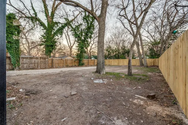a view of a house with yard and a tree