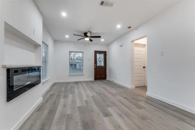 wooden floor in an empty room with a fireplace