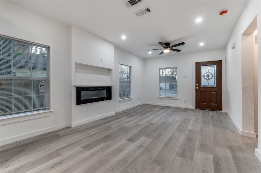 3242 Pine Street Dallas, TX 75215 - Photo 5 of 25 a view of an empty room with a fireplace and a window