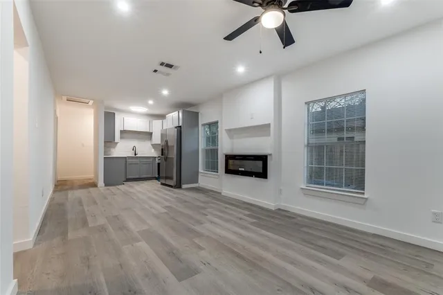 a view of kitchen and kitchen with furniture oven ceiling fan and window