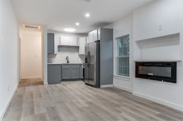 a kitchen with stainless steel appliances granite countertop a refrigerator and a sink