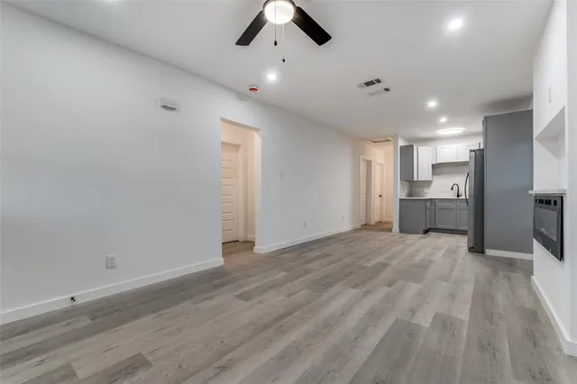 a view of an empty room with a kitchen