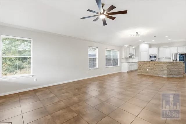 a view of a kitchen with furniture and a ceiling fan