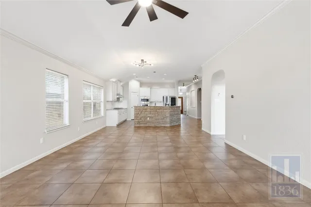 a view of a kitchen with furniture and a ceiling fan