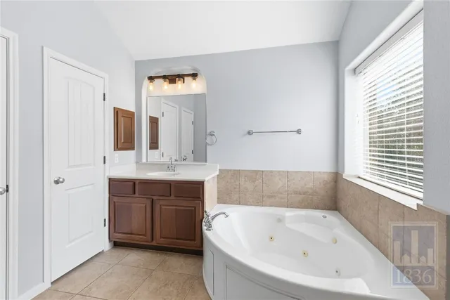 a bathroom with a bathtub and a sink