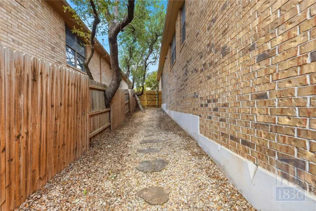 a view of a pathway door with wooden fence