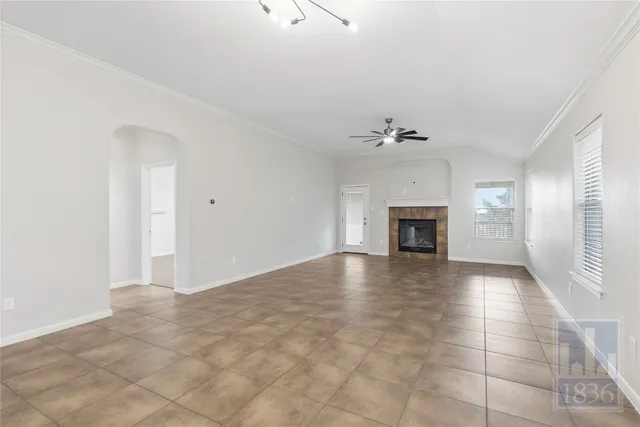 a view of a livingroom with a fireplace and a window