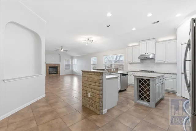 a kitchen with a refrigerator and a sink