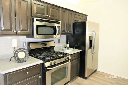 1420 South Yorktown Street Ridgecrest, CA 93555 - Photo 9 of 27 a kitchen with stainless steel appliances granite countertop a stove microwave and refrigerator