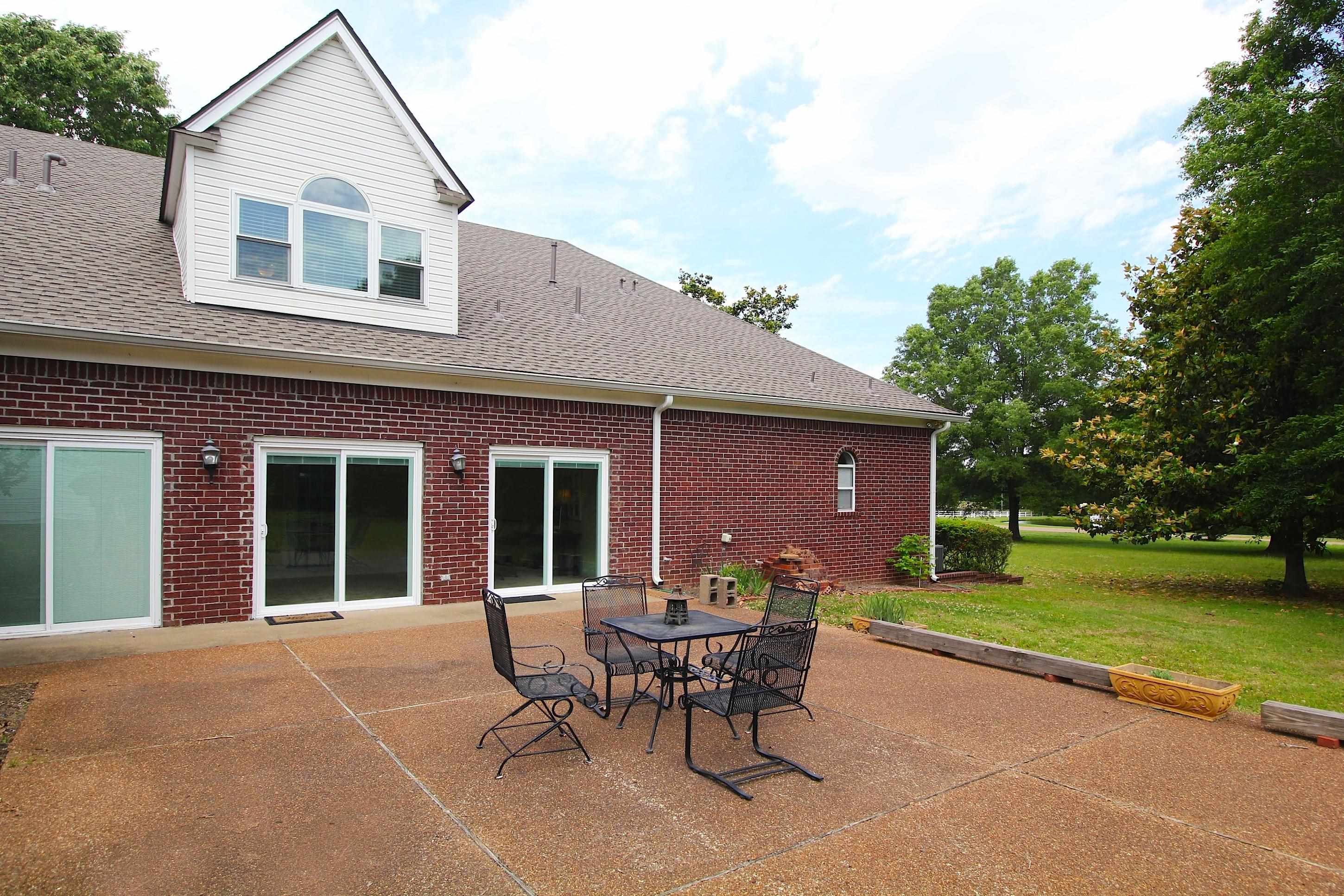 2550 North Reid Hooker Road Eads, TN 38028 - Photo 4 of 32 a backyard of a house with table and chairs