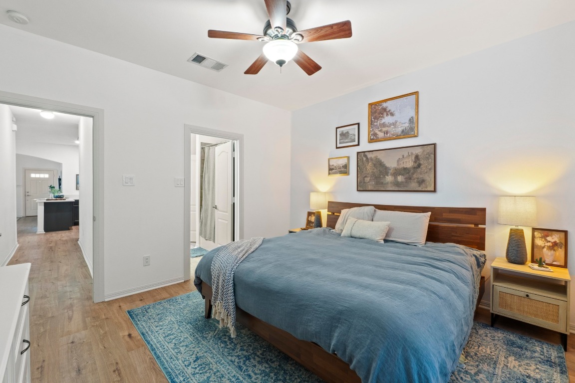 6801 Beckett Road, Unit 131R Austin, TX 78749 - Photo 15 of 26 a bedroom with a bed and a chandelier