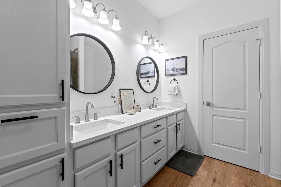 6801 Beckett Road, Unit 131R Austin, TX 78749 - Photo 17 of 26 a bathroom with a double vanity sink and a mirror with shower