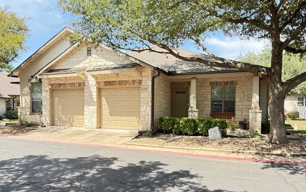 6801 Beckett Road, Unit 131R Austin, TX 78749 - Photo 2 of 26 a front view of a house with a yard and garage