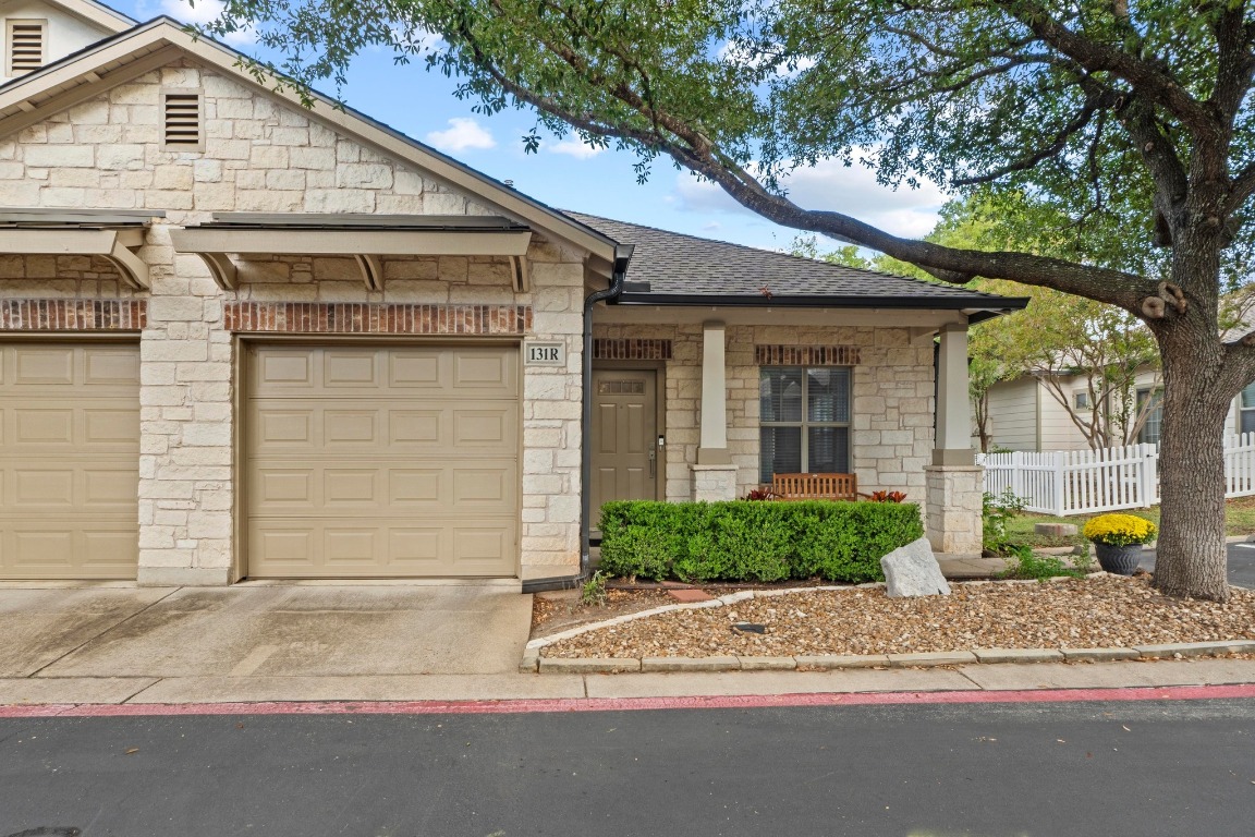 6801 Beckett Road, Unit 131R Austin, TX 78749 - Photo 25 of 26 a front view of a house with a yard and garage