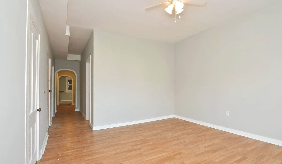 1838 South Racine Avenue Chicago, IL 60608 - Photo 11 of 16 a view of a room with wooden floor and a ceiling fan