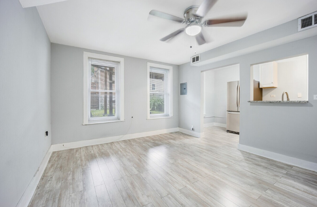 1838 South Racine Avenue Chicago, IL 60608 - Photo 5 of 16 a view of an empty room with a window and wooden floor