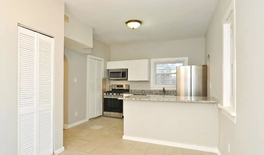 1838 South Racine Avenue Chicago, IL 60608 - Photo 10 of 16 a kitchen with stainless steel appliances granite countertop a stove a sink and a refrigerator