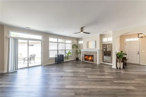 a kitchen with kitchen island granite countertop a sink cabinets and wooden floor