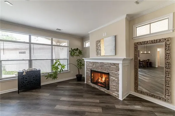 a kitchen with stainless steel appliances granite countertop a refrigerator a sink a stove and a wooden floors