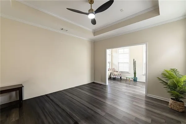 an empty room with a ceiling fan and window