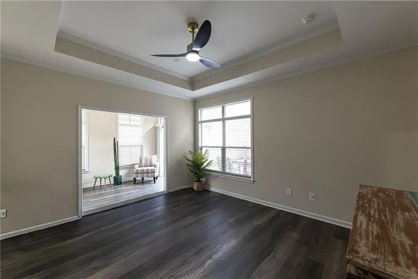 a kitchen with white cabinets and sink