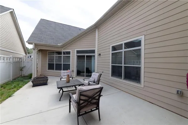 a view of a big house with a yard and a large tree
