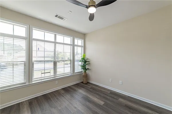 a view of an empty room with fireplace and a window
