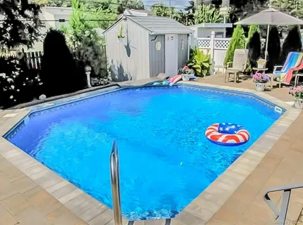 a view of swimming pool with an outdoor seating