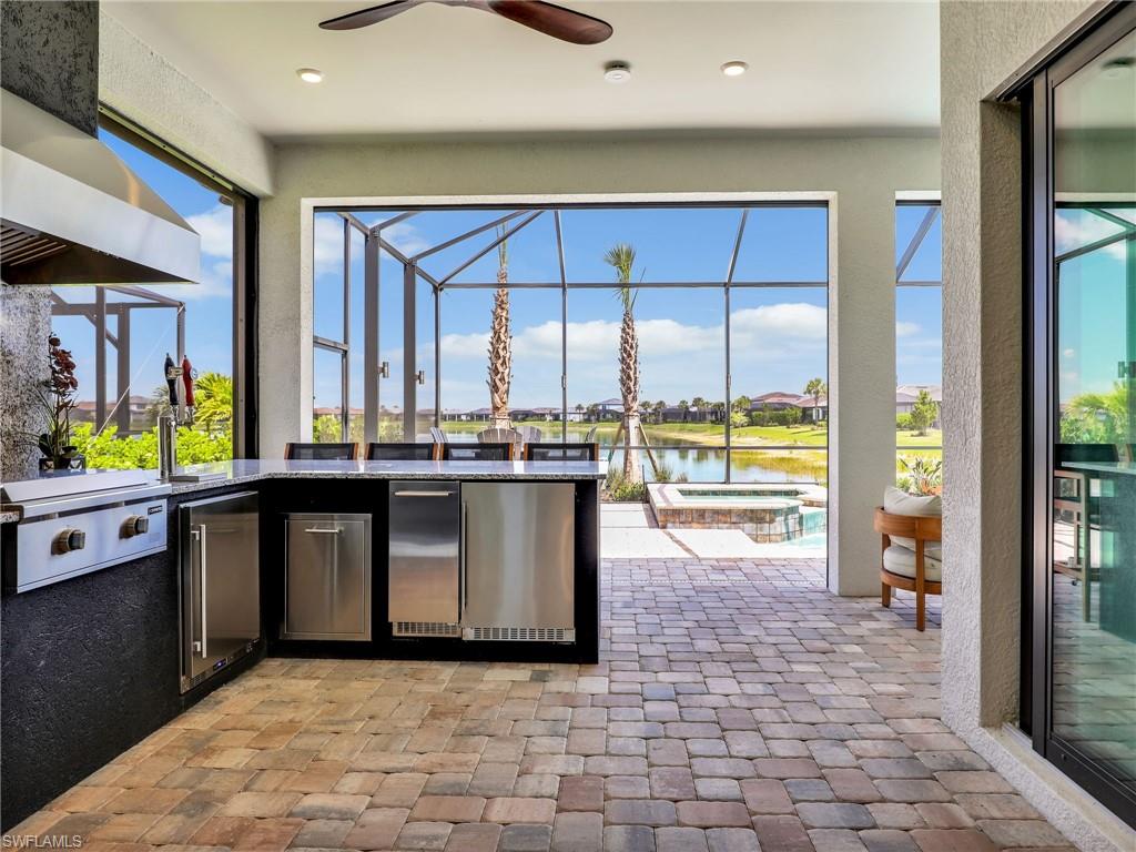 18412 Ridgeline Drive Estero, FL 33928 - Photo 21 of 50 a living room with stainless steel appliances kitchen island granite countertop a refrigerator and a stove