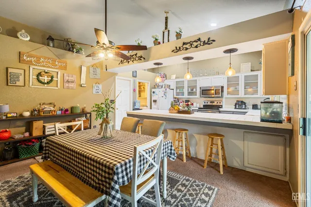 a large kitchen with a table and chairs