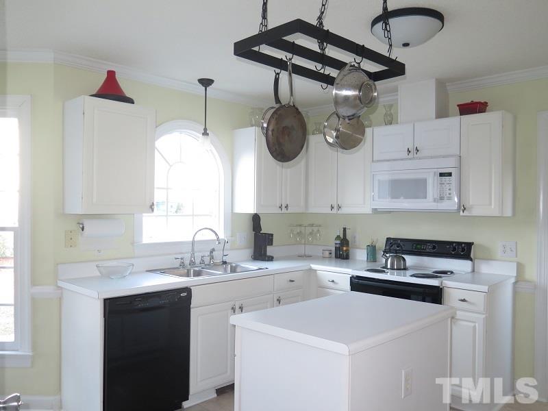 4441 Emmit Drive Raleigh, NC 27604 - Photo 8 of 19 a kitchen with stainless steel appliances a sink a stove and cabinets