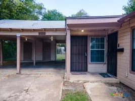 a view of an empty room with closet and a chandelier fan