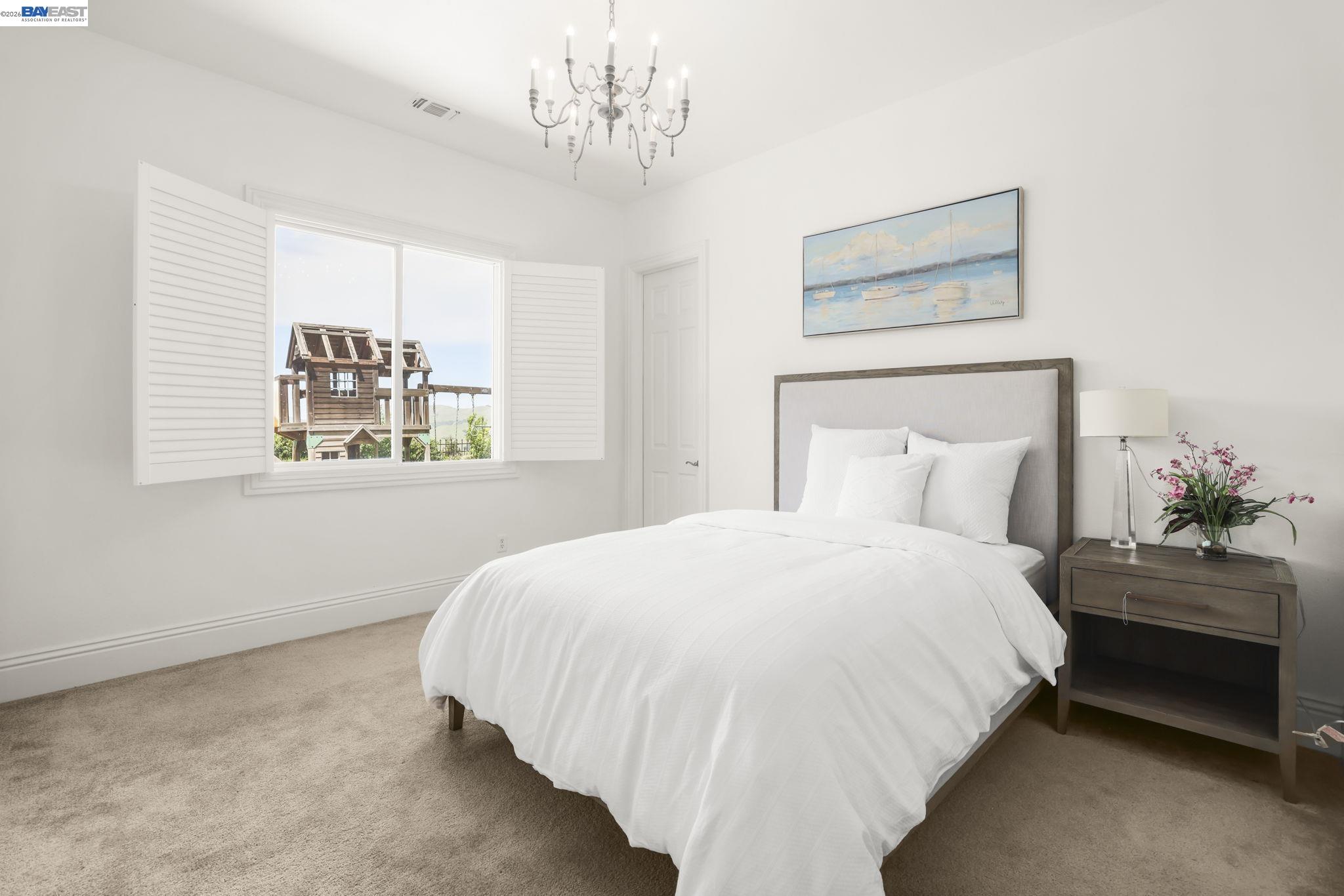 950 Winsford Court San Ramon, CA 94583 - Photo 16 of 68 a bedroom with a bed and a chandelier