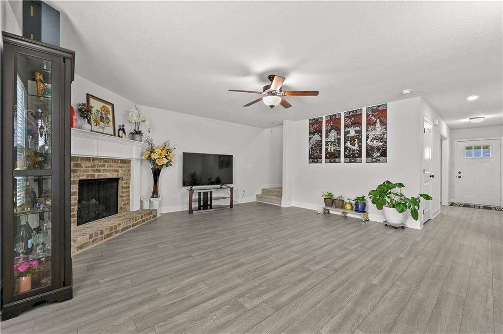 68 Suwannee Way Jefferson, GA 30549 - Photo 11 of 28 a living room with furniture a fireplace and a flat screen tv