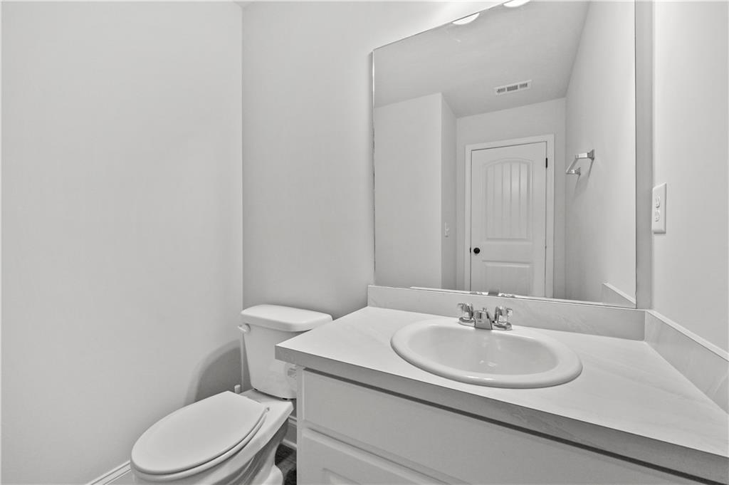 68 Suwannee Way Jefferson, GA 30549 - Photo 18 of 28 a bathroom with a sink toilet and a mirror