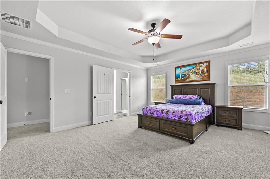 68 Suwannee Way Jefferson, GA 30549 - Photo 20 of 28 a bedroom with a bed a chandelier and pink walls