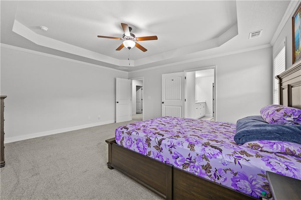 68 Suwannee Way Jefferson, GA 30549 - Photo 21 of 28 a bedroom with a bed and a chandelier