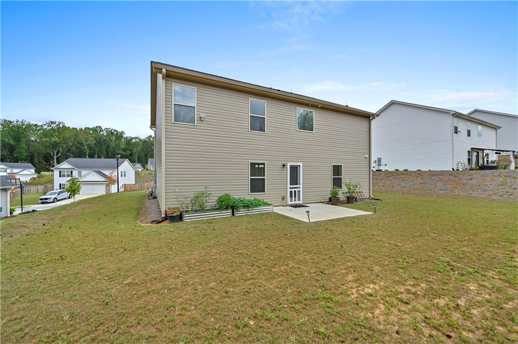 68 Suwannee Way Jefferson, GA 30549 - Photo 3 of 28 a view of a house with a yard and sitting area