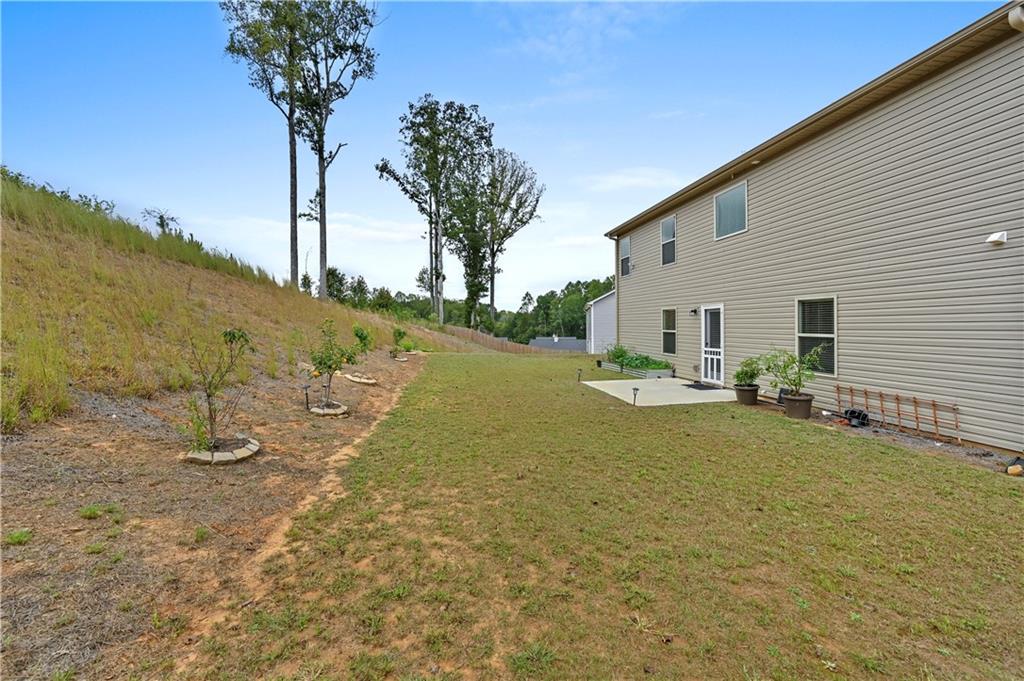 68 Suwannee Way Jefferson, GA 30549 - Photo 6 of 28 a view of a house with backyard and trees