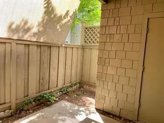 a small barn in front of a house with a yard