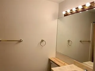 a kitchen that has a sink a stove and a refrigerator