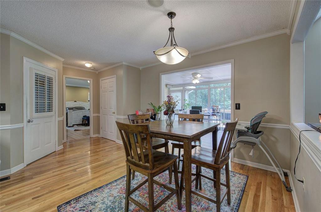 915 Oak Grove Road Carrollton, GA 30117 - Photo 13 of 57 a view of a dining room with furniture and wooden floor