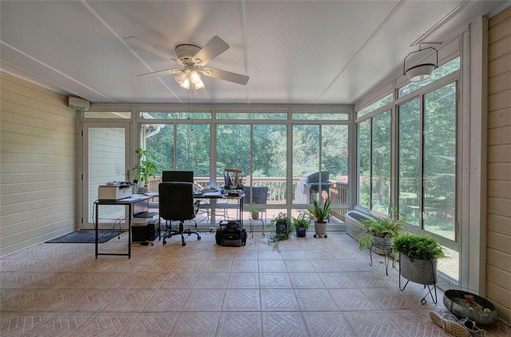 915 Oak Grove Road Carrollton, GA 30117 - Photo 19 of 57 a living room with furniture potted plant and a large window